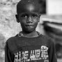 Four year old Malian boy Pascal Dako poses for a photograph in the street in which he lives in Diabaly, Mali 26 January 2013. This photograph is part of a picture package of portraits showing children living along the same street in the small rice growing community of the northern Malian town of Diabaly who in the month of January 2013 lived through a rapid chain of events in the Malian war.