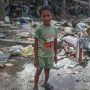 Nine year old Filipino boy Justin Coldora poses for a portrait in the super typhoon devastated city of Tacloban, Leyte province, Philippines 17  November 2013. Justin survived the storm by taking to higher ground around the port area with his family.