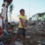 Nine year old Filipino boy Jomar Mosanto poses for a portrait in the super typhoon devastated city of Tacloban, Leyte province, Philippines 17  November 2013. Jomar, living close to the waters edge, took refuge in a third floor building and survived with his family but their house was destroyed.
