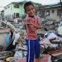 Eight year old Filipino boy Adjumar Nono poses for a portrait in the super typhoon devastated city of Tacloban, Leyte province, Philippines 17  November 2013. Adjumar, living close to the waters edge, took refuge in a third floor building and survived with his family but their house was destroyed.