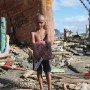 Nine year old Filipino boy Alexander Hernandez poses for a portrait in the super typhoon devastated city of Tacloban, Leyte province, Philippines 19 November 2013. Alexander lost his father to the storm but managed to escape to higher ground with his mother. They have lost everything and are seeking a new place to live making a shelter from the timber amongst debris.