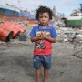 Four year old Filipino boy Kim Froiland poses for a portrait in the super typhoon devastated city of Tacloban, Leyte province, Philippines 19 November 2013. Kim, living in the Anibong area close to the waters edge in a shack, lost his home but survived the storm by fleeing to higher ground with his family. They have now returned to the area and are rebuilding their home.