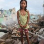 Nine year old  Filipino girl Janine Eder poses for a portrait in the village of Santa Rita on the super typhoon devastated Samar IslandPhilippines 20 November 2013. Janine survived the storm by fleeing with her family to the village of Lewaan which had a school in which they could shelter. They have now returned to rebuild their house.