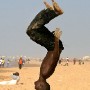 Senegalese boys sumersalt on the beach whilst people, walk, jog and train after a days work at Yoff beach, Dakar Senegal Tuesday 05 April 2005. Thursday 07 April is international health day. There is a high level of personal fitness amongst Senegalese and on several beaches around the city public fitness  instruction is offered by the government free of charge. However the Senegalese Health ministry released a report Tuesday 05 April of an outbreak of Cholera in Senegal which has claimed the lives of 54 people and infected some 3,400 others in the last week.
