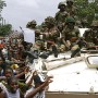 ECOMIL Peacekeepers met with extatic Liberian crowdes as they moved into town today, Monrovia 07 August 2003. his is the first deployment of peacekeepers into the city.<br />