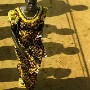 A Liberian woman walks to take her place in line to vote outside a polling station in Monrovia, Liberia. After 14 years of civil war the citizens of this impoverished nation head to the polls in 2005 to vote for a new president. There were 22 candidates in the running with football star George Weah and economist Ellen Johnson-Sirleaf tipped as favorites. The citizens of Monrovia, Liberia's capital, live without electricity or running water and often in overcrowded accommodation as a result of the influx of internally displaced people due to the civil war which ended with the departure of then President Charles Taylor and arrival of UN peacekeepers in 2003. Harvard graduate Ellen Johnson-Sirleaf won the election after it went into a second round run-off against George Weah. Ellen Johnson-Sirleaf thus became Africa's first ever elected president.