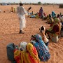 Sudanese Internally Displaced (IDP) woman  are instructed to sit and wait for water by an aid official in Muhajiriyah IDP camp, home to more than 40 000 refugees in Darfur, Sudan 21 October 2004. Speaking on Sunday 07 May 2006, Jan Egeland, the UN's top humanitarian official, said it is vital that UN peacekeepers are allowed into Sudan's Darfur region to assist in ending the humanitarian crisis. This as he begins a tour to Darfur to assess conditions there and in refugee camps in neighbouring Chad.The government of Sudan and the main Darfur rebel faction, the SLA, signed a peace agreement in Abuja, Nigeria on Friday 06 May 2006 after weeks of intense negotiations hoping to end the three years of fighting which has killed about 200,000 and  left about two million homeless.  