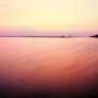 A couple sit on a beach at Sunset, Varkala, India 1997.