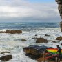 Andy Marr walks with his board before entering the ocean off a tidal pool wall for a session on the Cape South coast of South Africa 31 May 2011